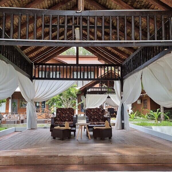 Open-air dining canopy with chairs and tables at Manas Resort resort grounds
