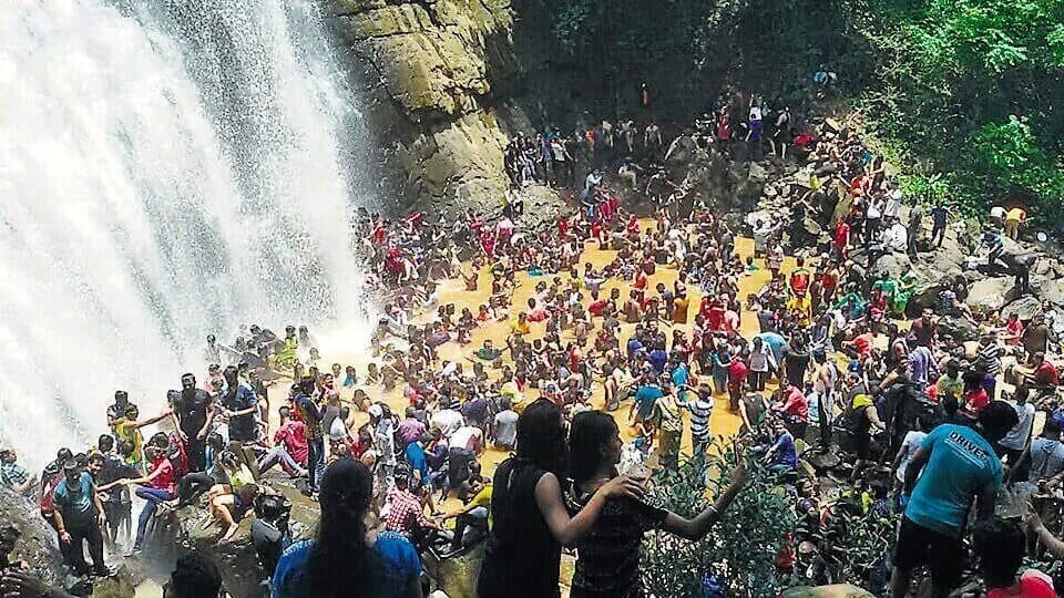 Visitors at a monsoon waterfall